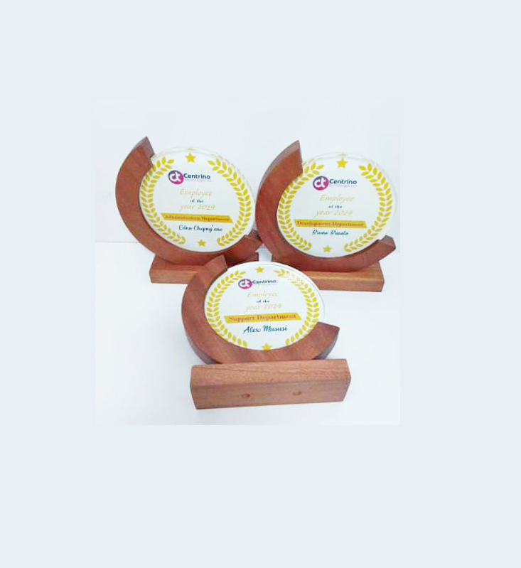 Individually named Employee of the Year awards produced by Almasi Prints in Nairobi, each piece carrying a different recipient name and department