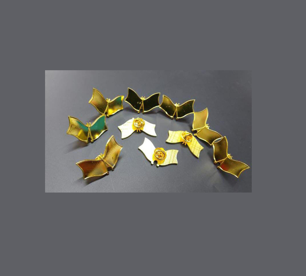 Lapel pin and badge production by Almasi Prints in Nairobi, gold butterfly lapel pins with enamel colour fill