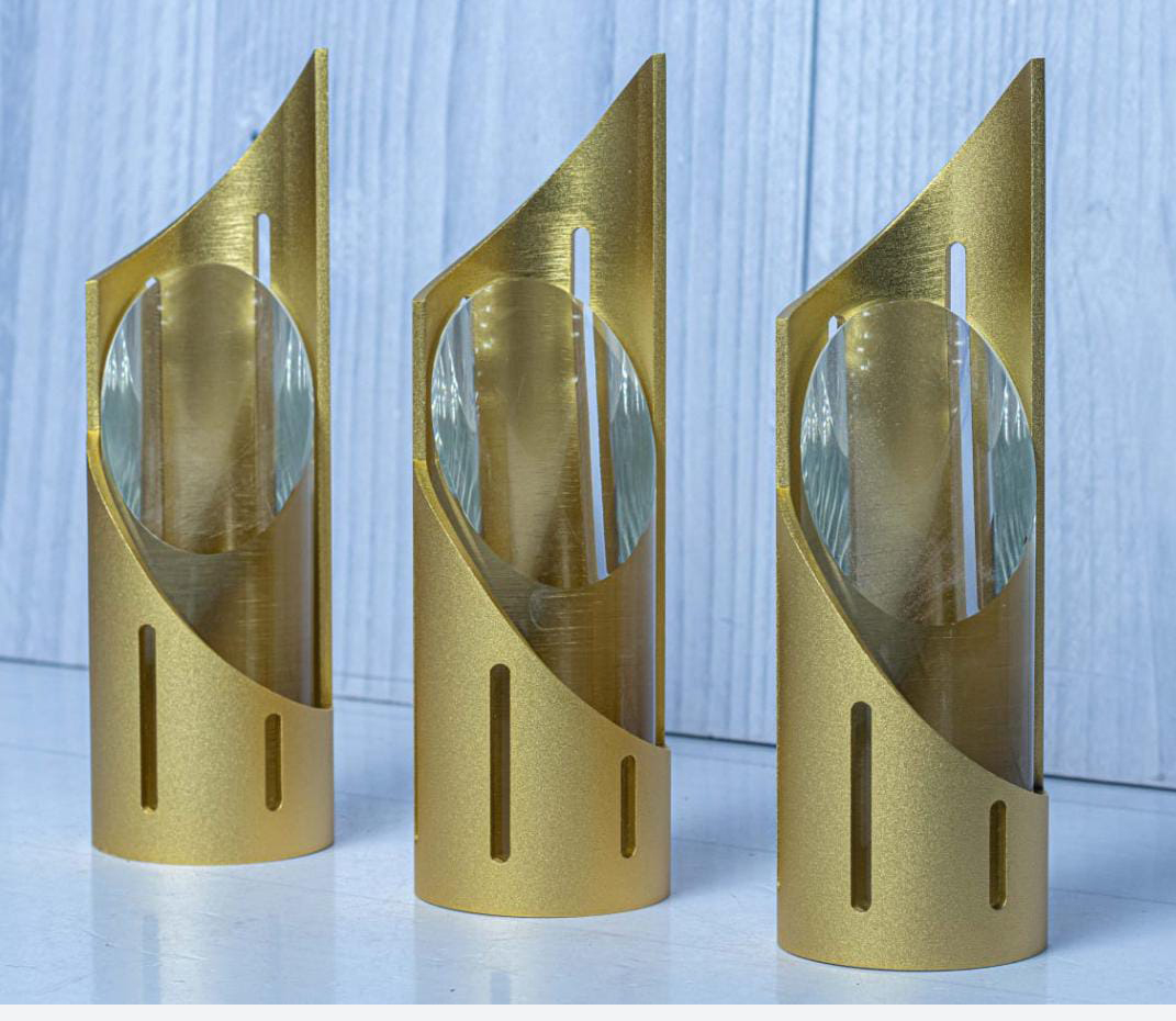 Metal and glass column award engraving in Nairobi by Almasi Prints, brushed gold curved awards with glass inserts